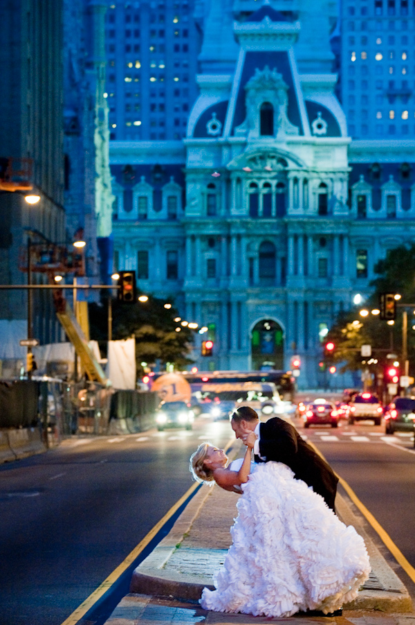 beautiful portrait of bride and groom dancing on street in downtown Philadelphia - photo by New York based wedding photographers Maloman Photographers
